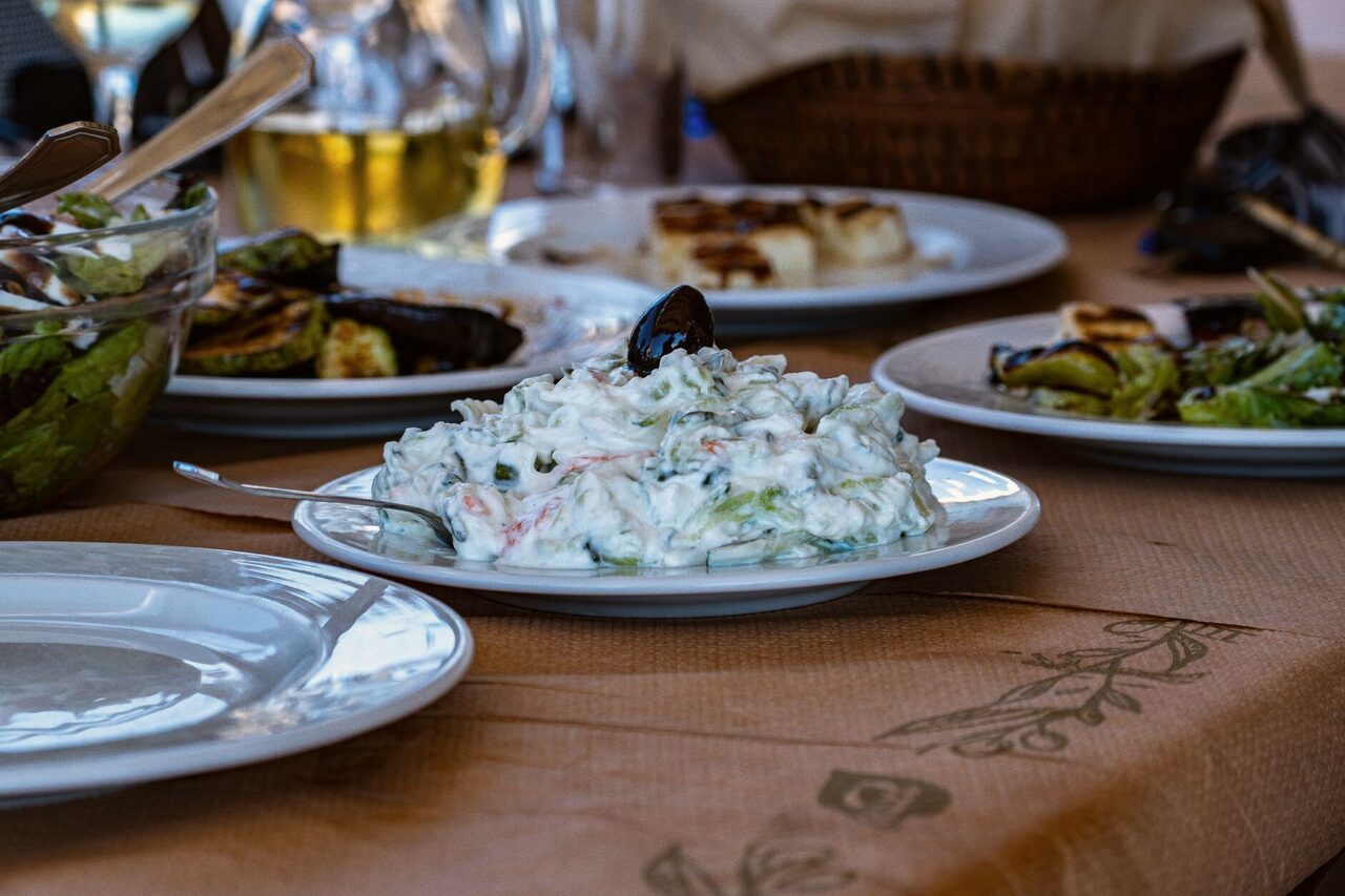 A table of small plates and a carafe of wine